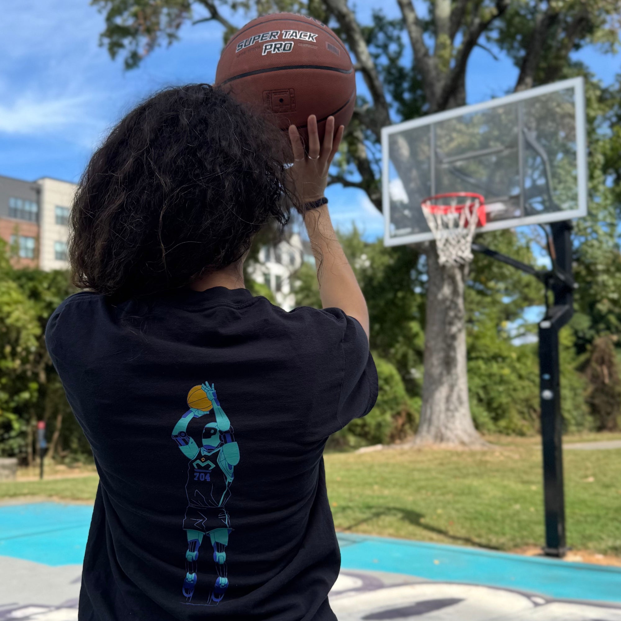 Tall Dentist Holding a Basketball on a court about to shoot